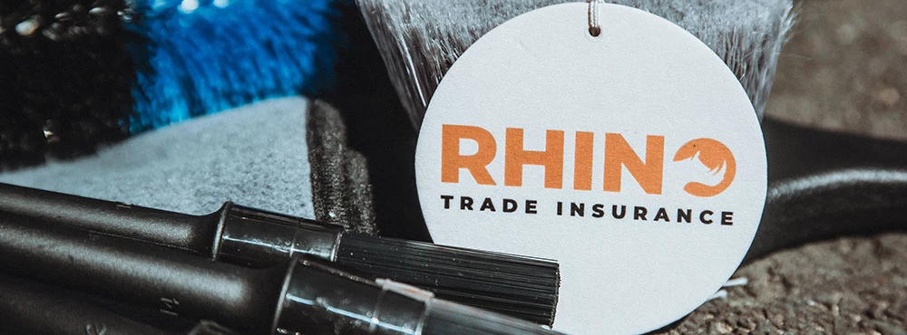 Rhino Trade Insurance tag next to paint brushes