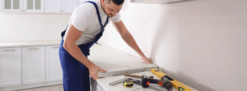 Man fitting built-in kitchen